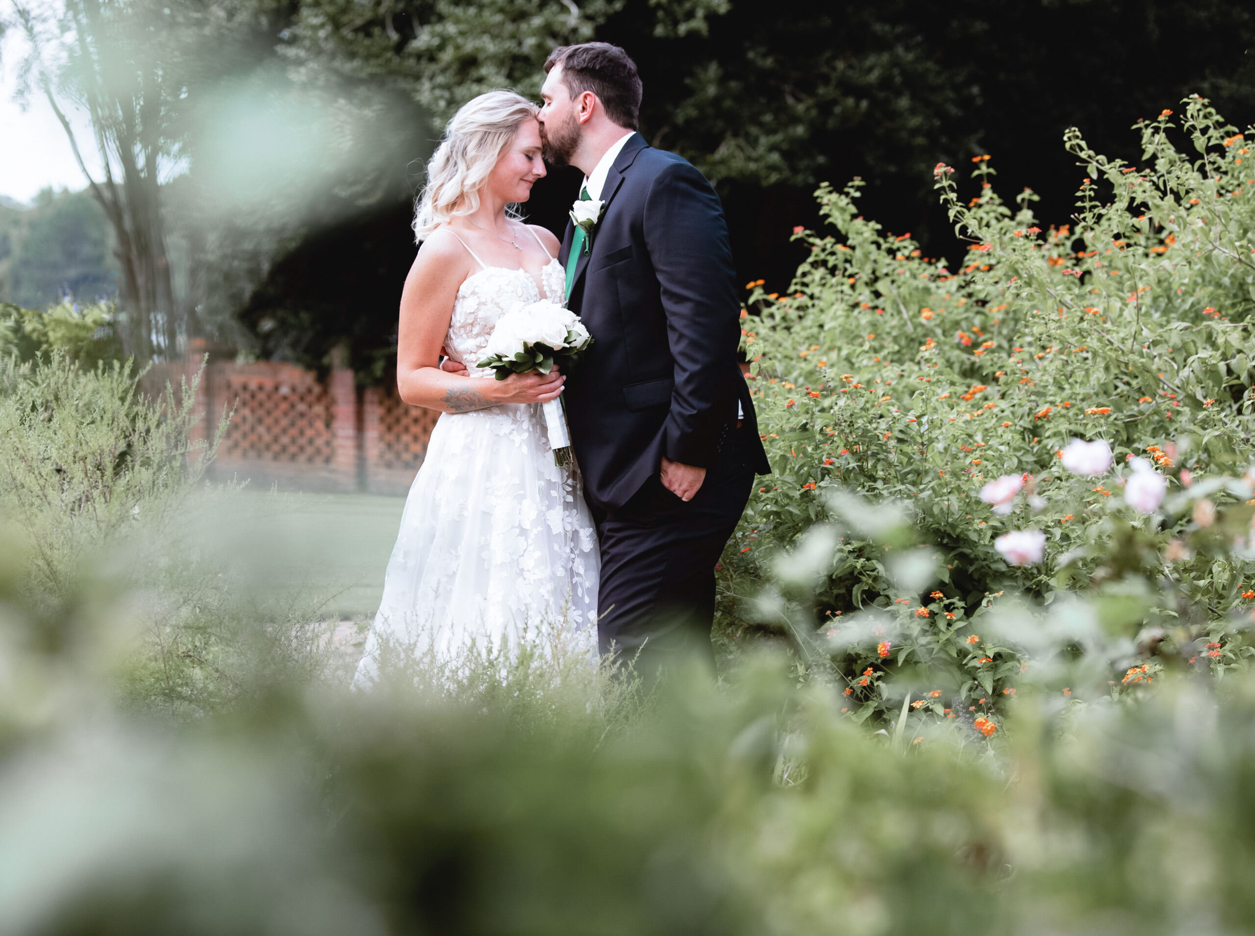 Atlanta editorial wedding photographer capturing an intimate garden portrait of a bride and groom surrounded by greenery
